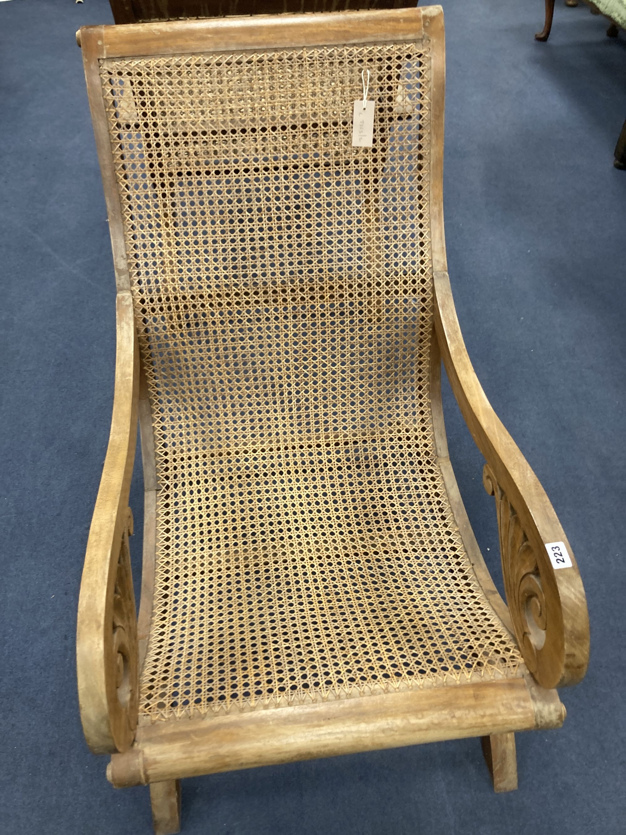 An early 20th century Anglo-Indian caned weathered teak armchair, width 57cm, depth 90cm, height 85cm